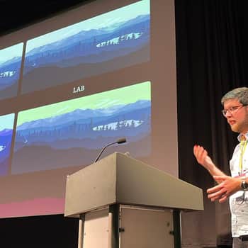 Me standing and speaking at a podium at State of the Browser